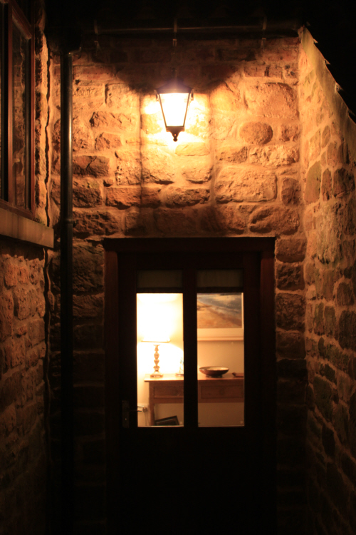 Traditional lighting over door to light dark corner by SEEC